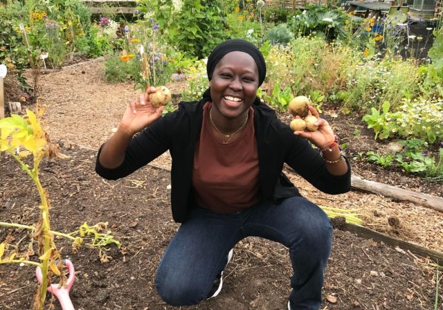 Propagation Place trainee holding up potatoes