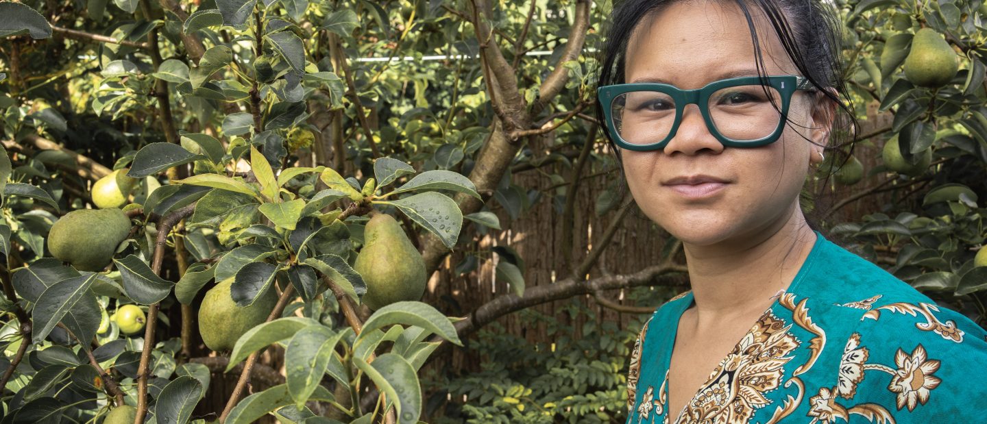 Cags Diep next to a fruit tree