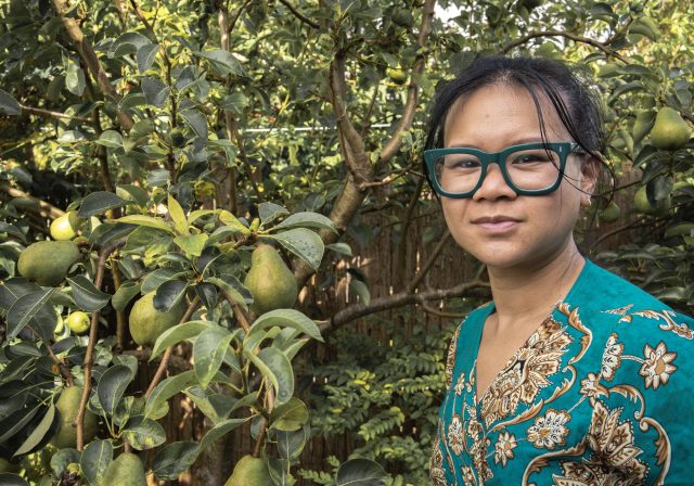Cags Diep next to a fruit tree