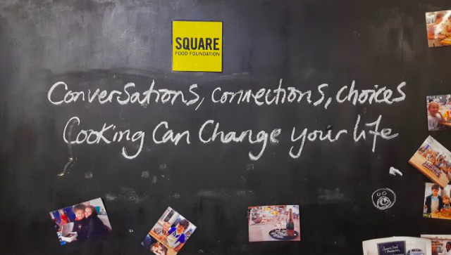 'Conversations, connections, choices. Cooking can change your life' written on a blackboard